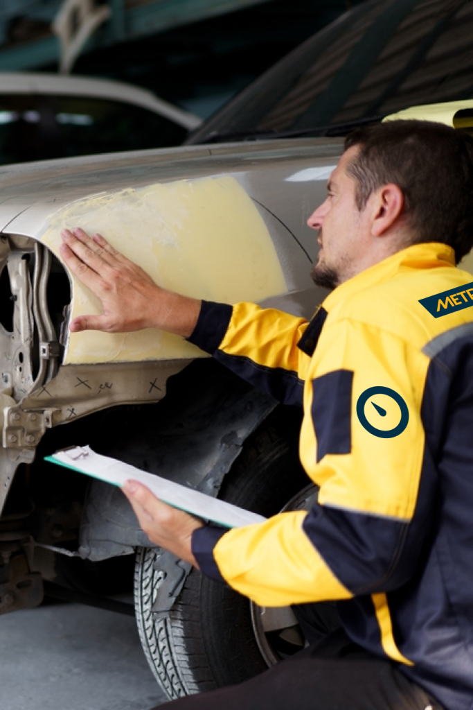 Metre 360 Master Mechanic in Metre 360 Uniform inspecting car part denting and painting job